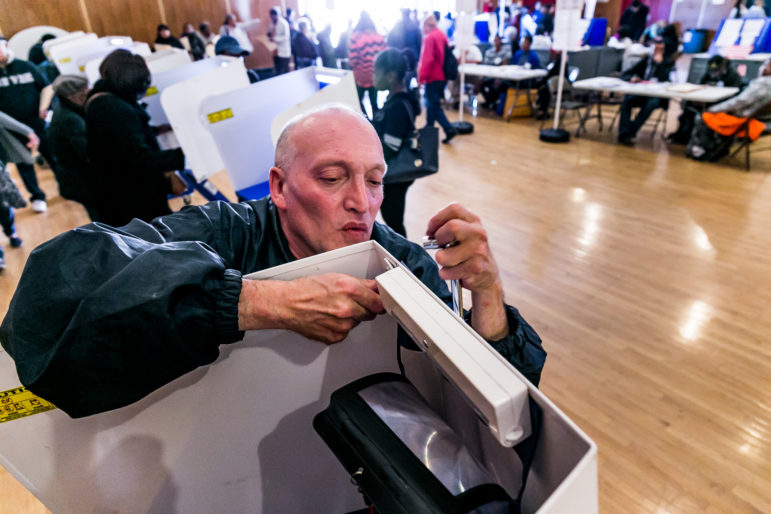 Martin Daniel Badonsky working to fix the light on a polling station at the community center auditorium located at 177 Dreiser loop in Co-op City.