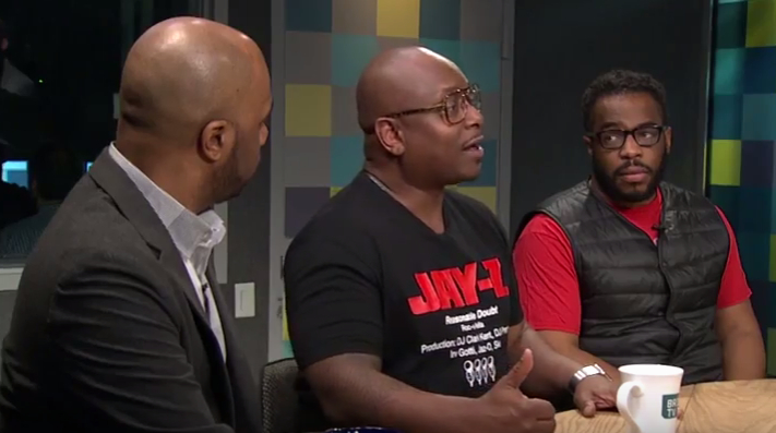 Combat Jack podcaster Reggie Osse speaks as Matthew Allen, left, and Wes Jackson look on.