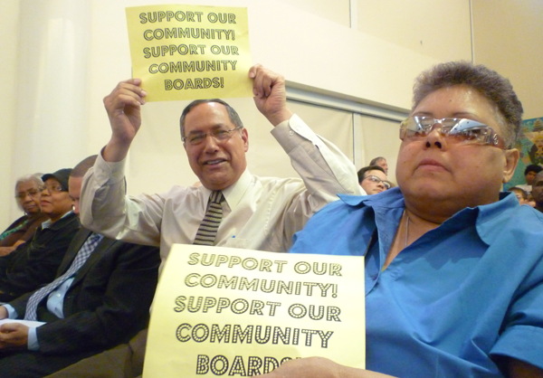 Bronx Community Board 2 district manager John Robert and member Joyce Campbell-Culler flash their feelings at Tuesday's hearing.