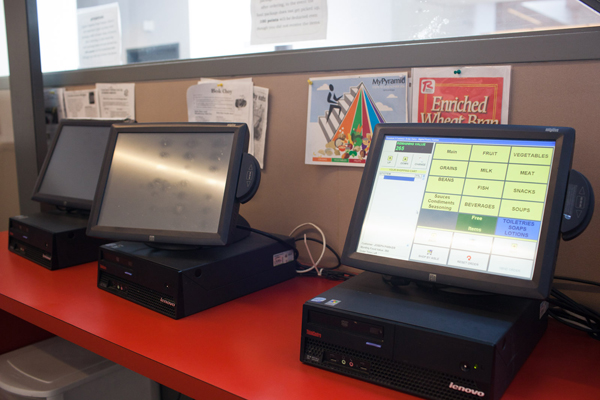 People coming for groceries place an order on one of four computer terminals, then volunteers and employees put together their order in a back room and bring it out within 15 minutes.