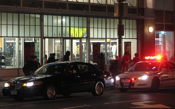 The NYPD pulls over a livery cab in Queens. Street hails are common in the outer boroughs, but illegal, so drivers have to weigh the risk of getting a ticket that can wipe out a day's profits.