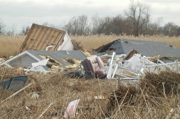 Roofs and small houses washed into a marsh in Staten Island.