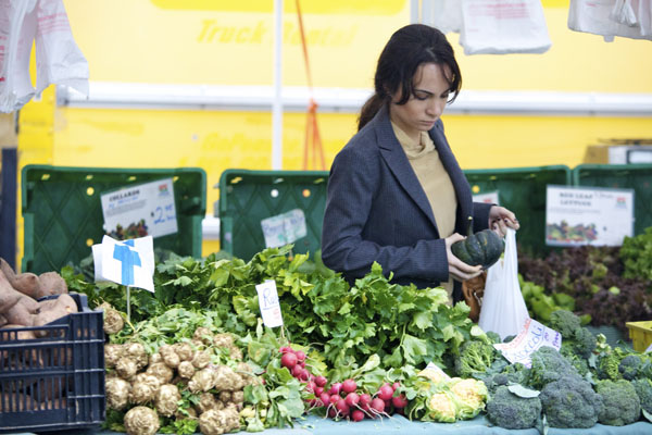 A shopper at the Bowling Green farmer's market. New York State is home to more than 36,000 farms—most of which are small, family farms ranging from one to 99-acres—that generate $5 billion in annual revenue.