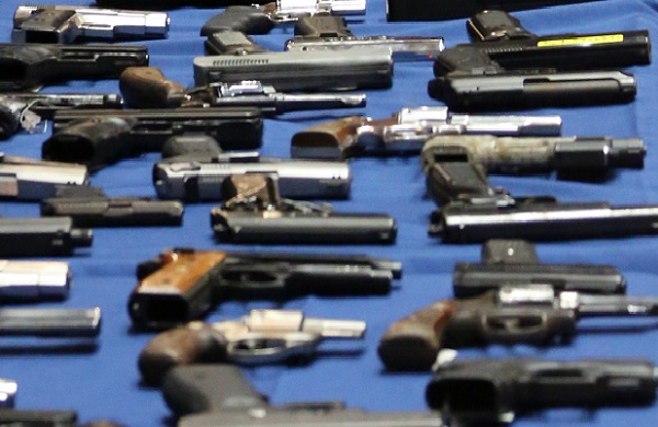 Guns displayed at an NYPD press conference. New York City has some of the toughest gun restrictions in the country, but they are undermined by lax regulations in other states.