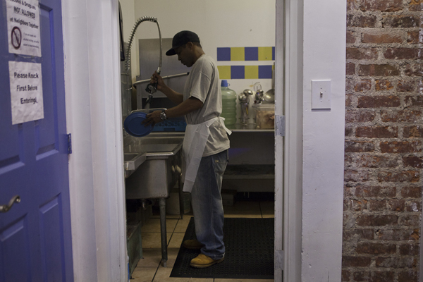 Robert Rodriguez, a food stamp recipient who does not receive welfare, says until now, people in his situation have not been required to work for their benefits. He's seen here volunteering at Neighbors Together, a Brooklyn anti-poverty agency.