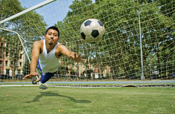 Azael Arturo makes a save at Thomas Jefferson Park in Manhattan, where a turf field had to be closed due to high lead levels.