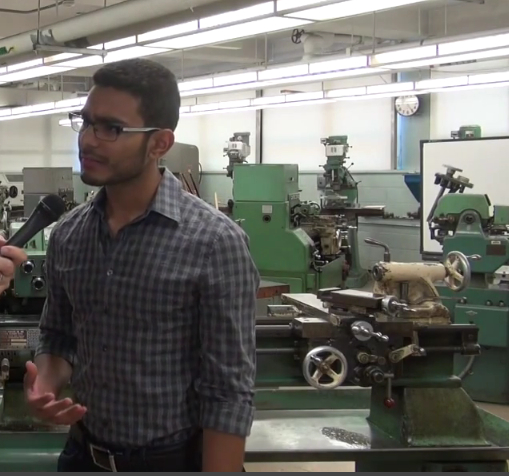 Giancarlos Llanos-Romero stands in a lab at Queensboro Community College where a technology program teaches students how to operate traditional machines and use cutting-edge technology.