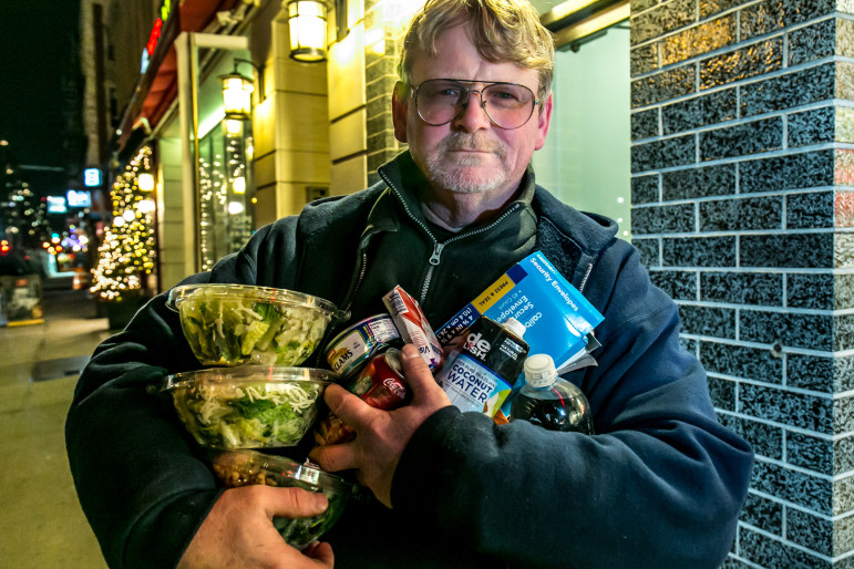 A freegan who goes by the name of 'Smiley' at the end of more than three hours of dumpster diving that spanned from 51st to 86th Street and Park to 1st Avenue. 