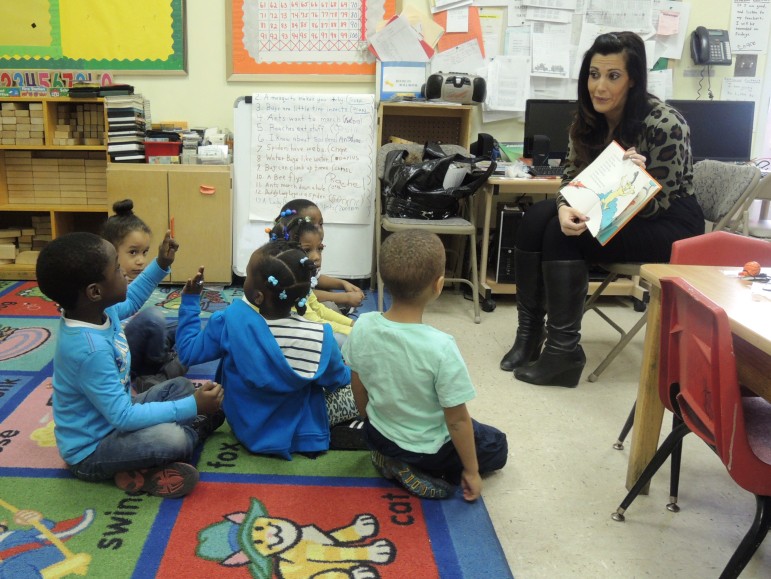 BCS volunteer participating in, "Read by Example," a service project for Spring into Action-2014.