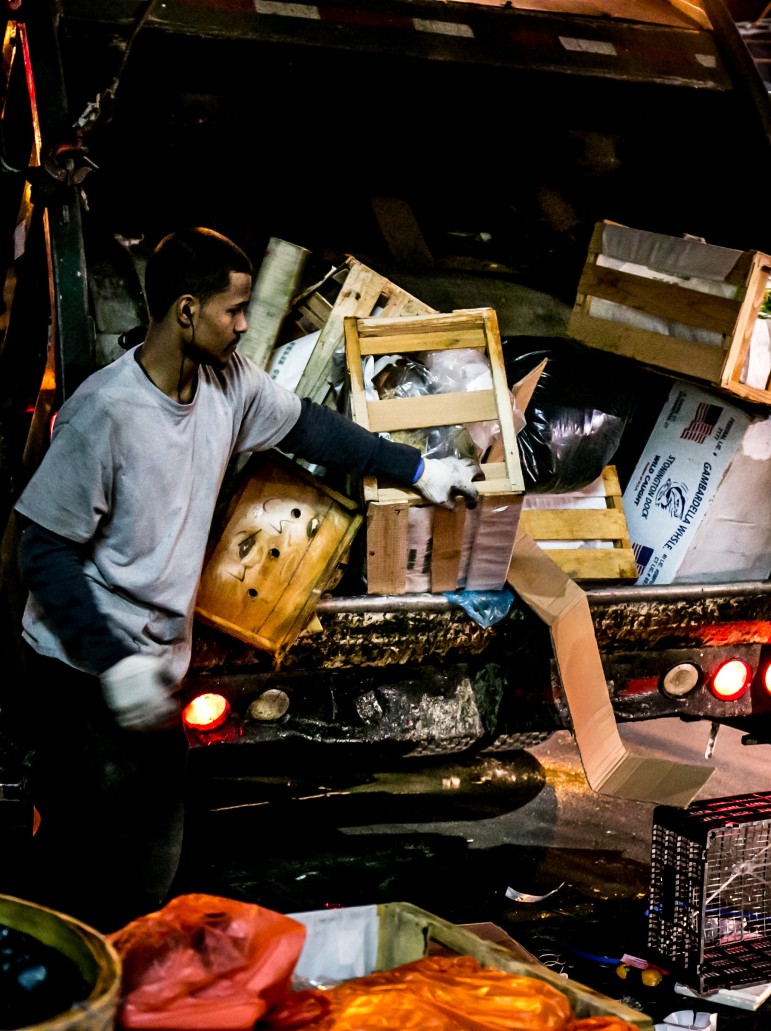 Commercial waste haulers at work late one night in May 2015.