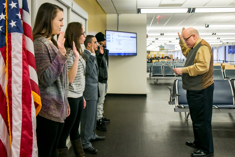 Supervisory Immigration Officer Joseph Mormino conducting a Citizenship Ceremony for children at the U.S. Citizenship and Immigration Services  offices in downtown Manhattan. left to right- Twin sisters Sarah Siebes and Emma Siebes (17 years) originally from Holland,  Rashed Alhanshali (18 years) originally from Yemen and Dario Cruz (21 years) originally from the Dominican Republic, derived their citizenship through their parents.