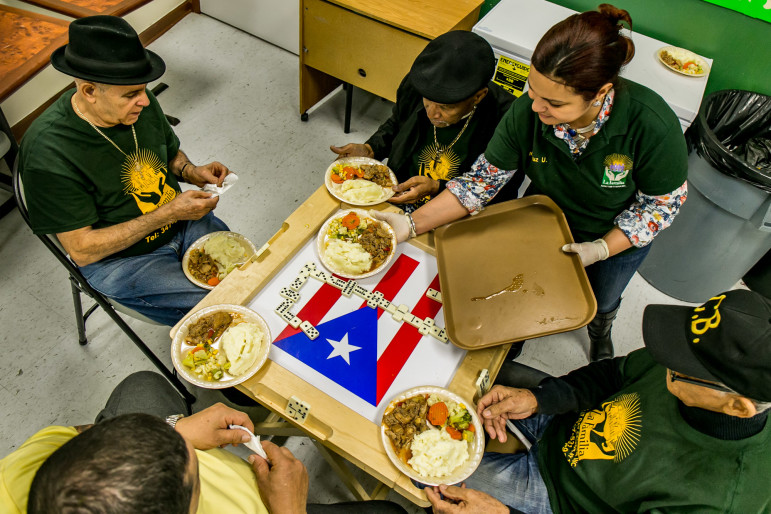 Mary Ulloa serves lunch to seniors at the La Familia Adult Day Center on Fulton street. Its owner fears her rent could triple after the rezoning.