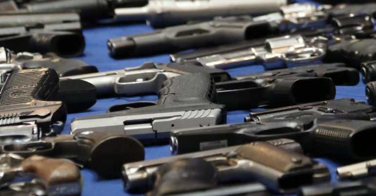 Illegal guns seized by the NYPD and displayed during an August 2013 press conference at City Hall. 