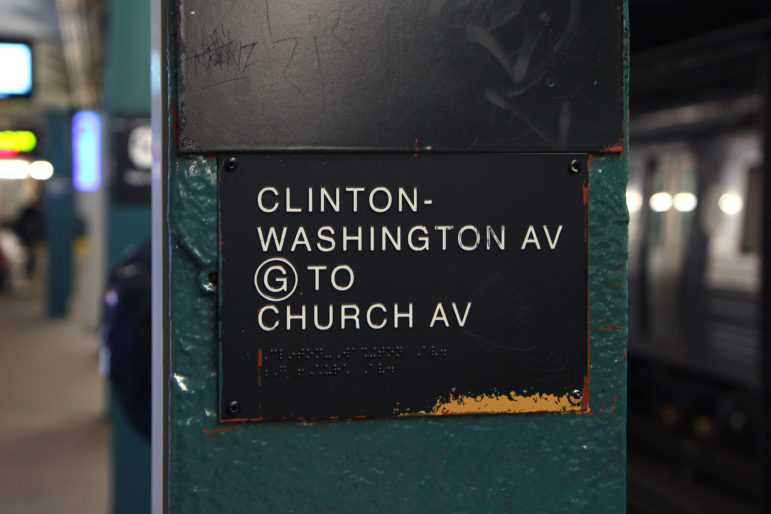 sign with braille and raised tactile letters