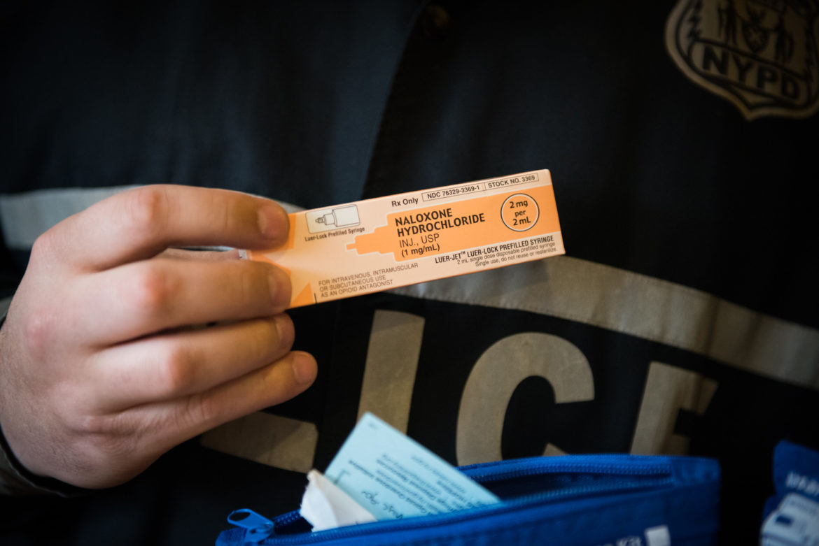 A person holds up a dose of Naloxone, a rescue dosage for opioid users who overdose.