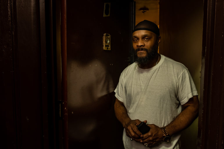 Bronx tenant in his apartment doorway