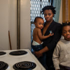 Bronx tenant and her two children in her apartment kitchen