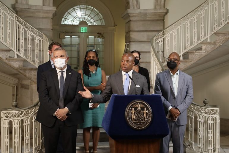 Mayor Eric Adams at a press conference podium in City Hall